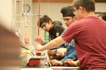 Students are working in a lab and learning about the importance of science, technology, and innovation in agriculture.